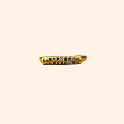 Introducing the Rainbow Signet Gold Ring by Roots Jewellery: an open-ended gold ring with a rectangular top adorned with three small rainbow-colored zircons, ideal for the fashion-forward individual.