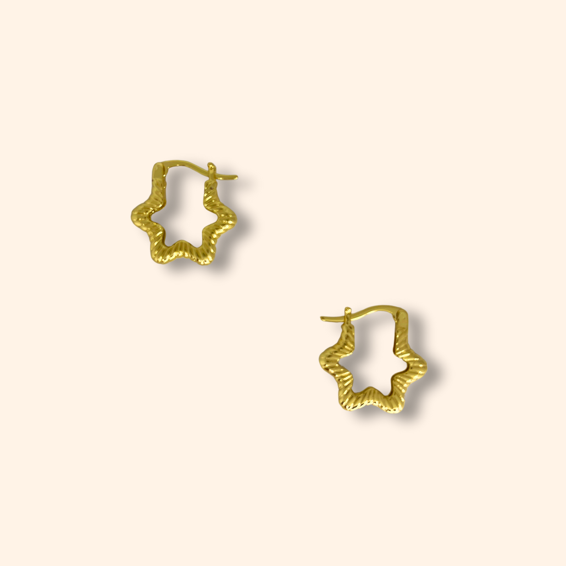 Roots Jewellery's Gold Star Hoop Earrings showcase a captivating star design set against a light background, expertly rhodium-plated for enhanced durability and shine.