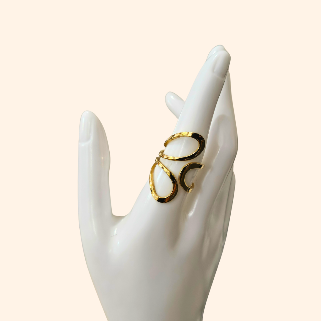 The Golden Petals Ring by Roots Jewellery embodies modern elegance with its geometric, open design set against a light background, making it a truly unique piece of jewellery.