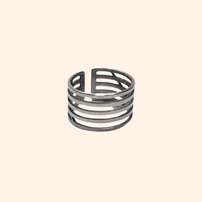 A Circle Ring from Roots Jewellery, featuring a silver color with multiple horizontal cutouts and an open back design, set against a neutral background.