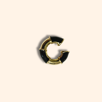 Introducing the Gold Ear Cuff with Colours by Roots Jewellery, this exquisite piece combines the elegance of gold with vibrant hues, elegantly set against a beige background. Crafted to perfection, it embodies sophistication and timeless charm.