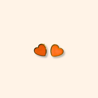 Introducing the Earring Set - Orange Hearts by Roots Jewellery: three exquisite pairs of earrings, including orange heart-shaped, gold flower-shaped, and white pearl studs, all beautifully displayed on a simple backdrop.