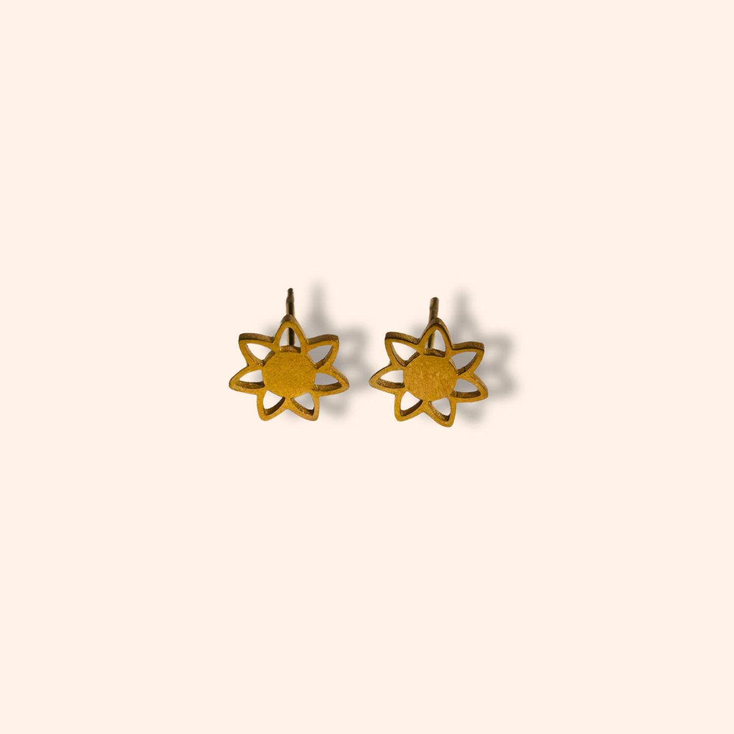 Introducing the Earring Set - Orange Hearts by Roots Jewellery: three exquisite pairs of earrings, including orange heart-shaped, gold flower-shaped, and white pearl studs, all beautifully displayed on a simple backdrop.